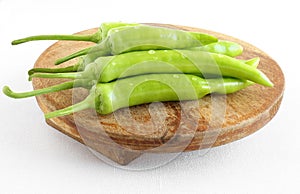 Indian Organic Long Green Chiles on a Wooden Table photo