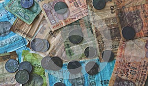 Indian paper currency with coins on isolated black background, concept of savings and investment