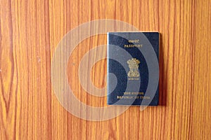 Indian Passport book on wooden table hardwood floor. Close up. Travel tourism and holiday vacation concept. Mockup. Top high angel