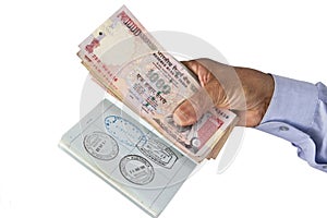 Indian Passport and Indian Rupees in hand photo