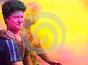 Indian People playing with colorful gulal on Holi.