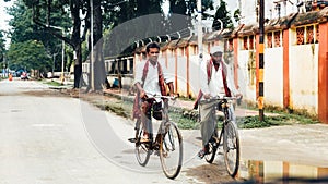 Indian people riding bicycles on the street while raining at Bodh Gaya, Bihar, India