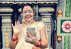 Indian people using mobile phone at the colorful temple