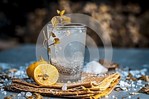 Indian popular summer drink SABJA NIMBUPANI/SWEET BASIL DRINK WITH LEMON and sugar in dark Gothic colors on a wooden surface photo