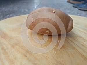 Indian Potato in a wooden table. Potato is testy cooking