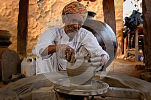 Indian potter at work. Handwork craft from Shilpagram, Udaipur, Rajasthan, India