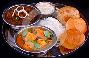 Indian Punjabi meal-curries served with rice and puri