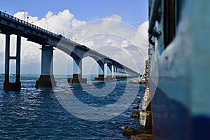 Indian railway train on the railroad bridge over the sea called Pamban Bridge. It connecting Rameswaram on the Island with