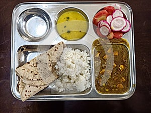 Indian regular vegetarian food chapati and sabji with salad in thali