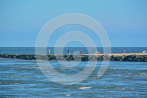 The Indian River Inlet flowing past the jetty on the Atlantic Ocean. At the Delaware Seashore State Park in Rehoboth Beach, Sussex