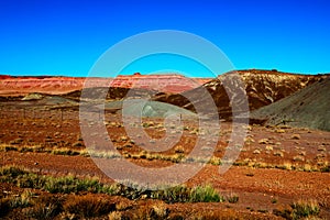 Indian Route 15 clings to the edge of a sandstone mesa in Apache County like this one