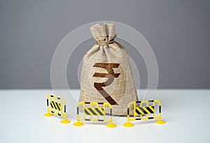 Indian rupee bag is fenced with barriers. Capital restrictions. photo