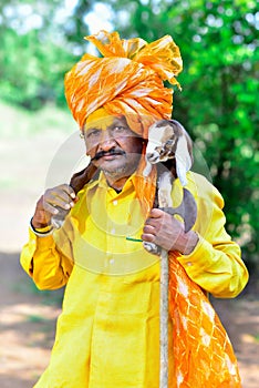 Indian Rural Man Holding Baby Sheep In His Hands Traditional Dress