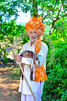 Indian Rural Man Holding Baby Sheep In His Hands Traditional Dress