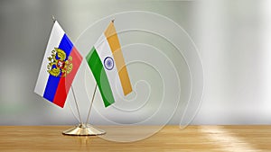 Indian and Russian flag pair on a desk over defocused background