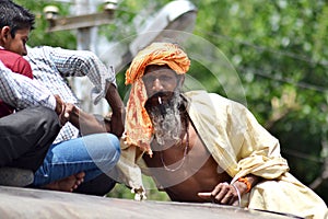 Indian sadhu climbing on train roof