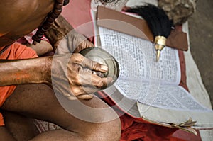 Indian Sadhu playing and reading in the street photo