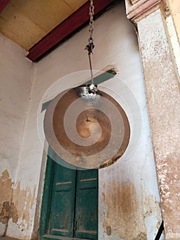 Indian School Bell Traditional icon, hanging flat golden bell in Ramnagar fort