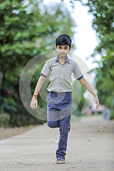 Indian school boy playing hop-scotch in playground