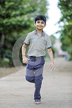 Indian school boy playing hop-scotch in playground