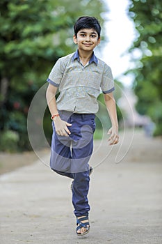 Indian school boy playing hop-scotch in playground