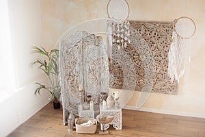 Indian screen and dream catchers. A corner for meditation in the bedroom. Esoteric boho room decor