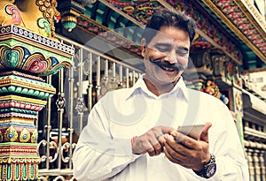 Indian senior man using mobile phone