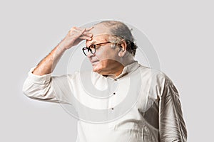 Indian senior or old man having ache or body pain, sad expressions