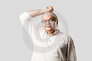 Indian senior or old man having ache or body pain, sad expressions