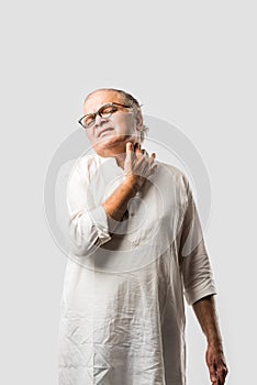 Indian senior or old man having ache or body pain, sad expressions