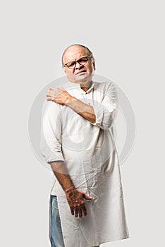 Indian senior or old man having ache or body pain, sad expressions