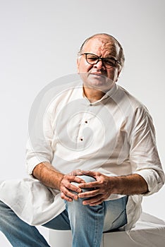 Indian senior or old man having ache or body pain, sad expressions