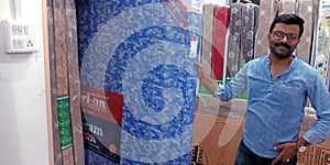 an indian shopkeeper selling caution branded staff showroom in India