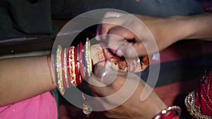 Indian sister tying rakhi, Raksha bandhan to brother`s wrist during festival or ceremony