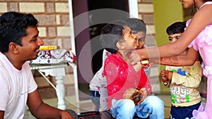 Indian sister tying rakhi, Raksha bandhan to brother`s wrist during festival or ceremony