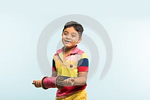 Indian small kid or boy holding spindal or chakri on Makar Sankranti festival, ready to fly Kite