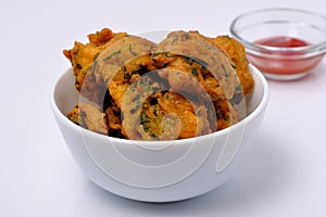 Indian snack pakora with tomato sauce or chutney
