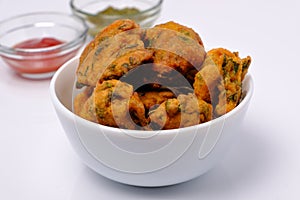 Indian snack pakora with tomato sauce or chutney