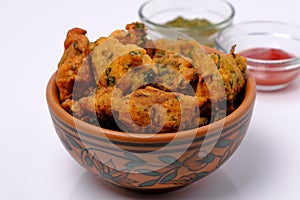 Indian snack pakora with tomato sauce or chutney