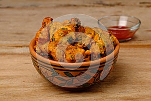 Indian snack pakora with tomato sauce or chutney