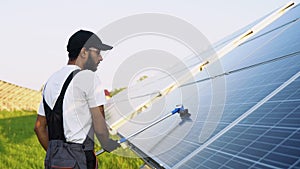 Indian solar panel worker use brushes to clean dust from solar panels to produce and sell electricity. Energy technology