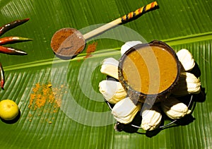 Indian spices  with a bowl of porridge  in a green backgorund