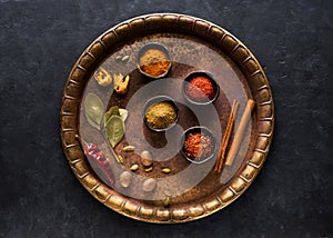 Indian spices on a vintage brass tray photo