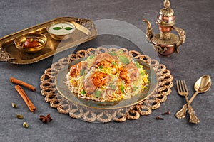 Indian spicy food Butter Chicken Biryani or Murgh Makhani Biryani with raita and gulab jamun Served in a dish side view ramdan