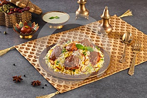 Indian spicy food Dum Gosht Biryani or Mutton bhuna Biryani with raita and gulab jamun Served in a dish side view ramdan food on