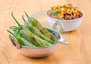 Indian Spicy Green Chilli Pickle with Mango Pickle on Wooden Background