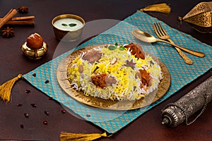 Indian spisy food Murgh Tikka Biryani or Chicken Tikka Biryani with raita and gulab jamun Served in a dish side view ramdan food