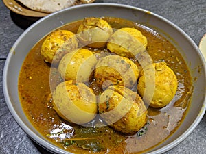 An Indian spread of spicy Egg curry or Egg Masala in a bowl