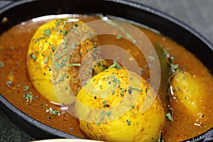 An Indian spread of spicy Egg curry or Egg Masala in a bowl