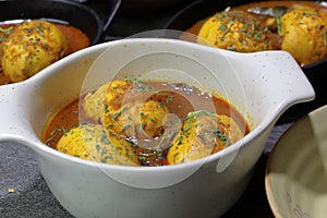 An Indian spread of spicy Egg curry or Egg Masala in a bowl